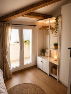 a bedroom with a window and a bed and a room with a window at Una Baita nel Centro di Pescara con Parcheggio Privato - Palazzo Carolina in Pescara