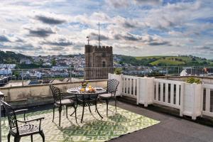 a patio with a table and chairs on a balcony at Finest Retreats - Curricle in Bideford