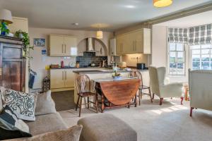 a kitchen and living room with a table and chairs at Finest Retreats - Curricle in Bideford