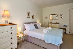 a bedroom with a bed with towels on it at Finest Retreats - Curricle in Bideford