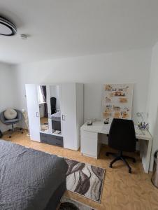 a bedroom with a bed and a desk and a chair at Holm in Melsungen +6 photos