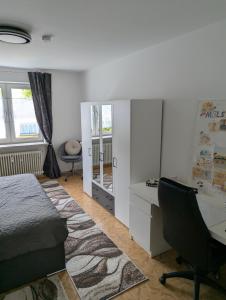 a bedroom with a bed and a desk and a chair at Holm in Melsungen