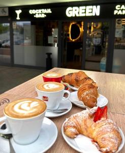 a table with two cups of coffee and croissants at Monolocale moderno - Colazione Inclusa in Vimodrone