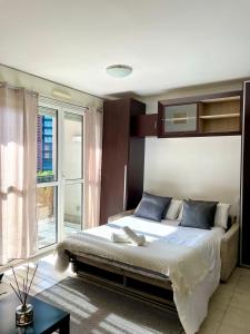 a bedroom with a large bed and a window at Monolocale moderno - Colazione Inclusa in Vimodrone