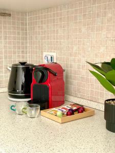 a kitchen counter with a coffee maker and a toaster at Monolocale moderno - Colazione Inclusa in Vimodrone