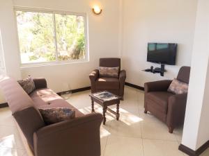 a living room with two couches and a tv at Elegant Villa with Sea View in Victoria in Victoria