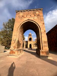 a shadow of a person standing in front of an arch at Арев in Yerevan