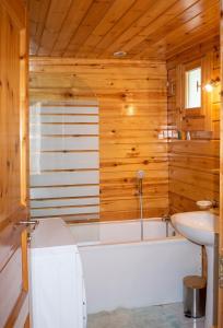 a bathroom with a white tub and a sink at Chalet cosy à Sixt-Fer-à-Cheval avec vue sur la montagne in Sixt +4 photos