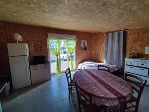 a room with a table and a kitchen with a table and chairs at Studio des Mèzerets in La Chapelle-Engerbold
