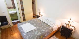 a bedroom with a bed and a sink and a mirror at Spacious House in Seia with Stunning Mountain Views, 150 m² in Seia