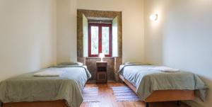 a room with two beds and a window at Spacious House in Seia with Stunning Mountain Views, 150 m² in Seia