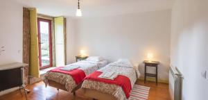 two twin beds in a room with a tv at Spacious House in Seia with Stunning Mountain Views, 150 m² in Seia