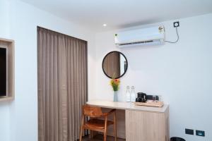a room with a mirror and a table with a mirror at Metro park inn in Coimbatore