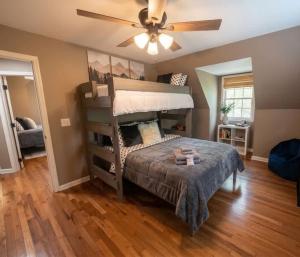 a bedroom with a bunk bed and a ceiling fan at Mountain Hideaway at Cabins in the Clouds in Rising Fawn