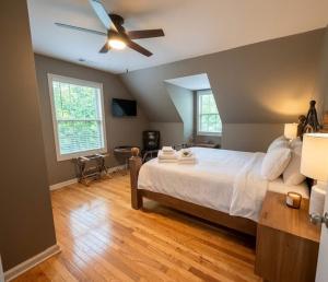 a bedroom with a bed and a ceiling fan at Mountain Hideaway at Cabins in the Clouds in Rising Fawn