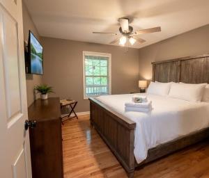 a bedroom with a large bed with a ceiling fan at Mountain Hideaway at Cabins in the Clouds in Rising Fawn