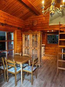 a dining room with a table and chairs in a cabin at Seesen Private Lodge in Seesen +22 photos