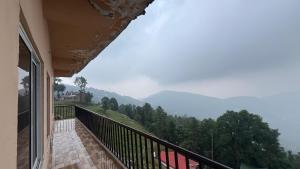 a balcony with a view of a mountain at Shareef Lodge in Murree