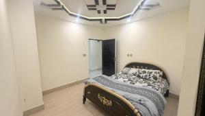 a bedroom with a bed in a room with a ceiling at Shareef Lodge in Murree