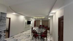 a dining room with a table and chairs at Shareef Lodge in Murree