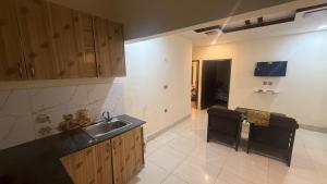a kitchen with a sink and a counter top at Shareef Lodge in Murree