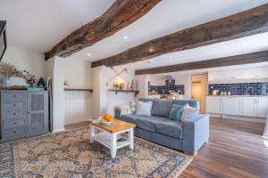a living room with a couch and a table at Spacious Cottage in Dartmoor in Hennock