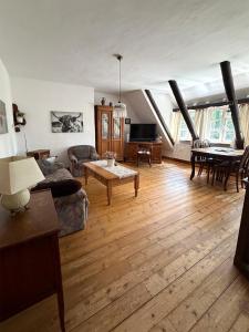 a living room with a couch and a table at Lieblingsnest in Bad Fallingbostel +2 photos