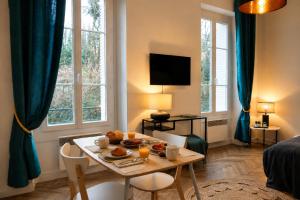 a living room with a table with food on it at le Riviera in Aix-les-Bains