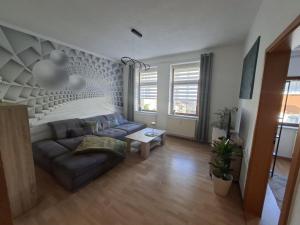 a living room with a couch and a table at NEU! Fereinwohnung Greim in Lengenfeld +1 photo