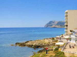 a view of the ocean and a building at Seafront Cala Ratjada Apartment in Cala Ratjada +22 photos