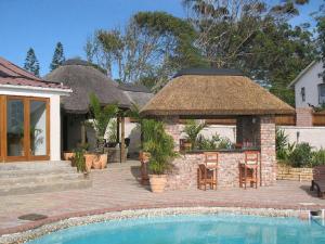 a house with a pool and a pavilion next to a house at Aviators Paradise Guest House in Mossel Bay