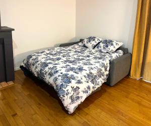 a bed with a blanket and two pillows on it at Emmanon - Appartement in La Coquille +2 photos