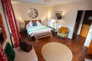 a hotel room with a bed and a chair at Hotel Vorderburg in Schlitz +166 photos