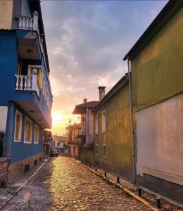 a cobblestone street in an old town at sunset at Za Apartment 2 in Korçë