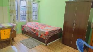 a bedroom with a bed and a cabinet and a table at Local feeling in Nepal in Bhaktapur