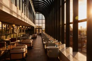 a restaurant with tables and chairs in a building at Jumeirah Carlton Tower London in London