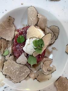 a plate of food with a dessert with a plant on it at La casa del tartufo in Torri in Sabina