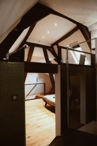 a attic room with a bed and a mirror at B&B De Mout in Diest