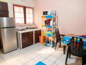 a kitchen with a stainless steel refrigerator and a table at Studio confortable à Capesterre-de-Marie-Galante - 20 m² in Capesterre +6 photos