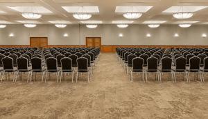 an empty room with chairs and tables and lights at Fiesta Americana Reforma in Mexico City +83 photos