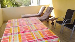 a room with a bed and two chairs and a window at Elegant Apartment in Trou aux Biches / 125 m² / Mountain View in Trou aux Biches