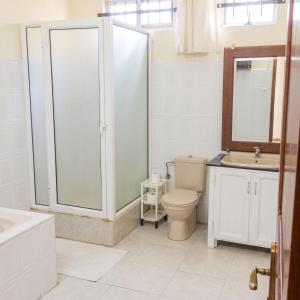 a bathroom with a toilet and a shower and a sink at Elegant Apartment in Trou aux Biches / 125 m² / Mountain View in Trou aux Biches
