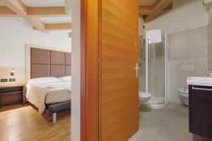 a bedroom with a bed and a bathroom with a shower at Cameras Mori in Mori +118 photos