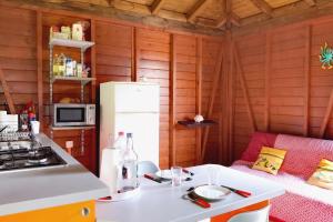 a kitchen with a white refrigerator and a stove at Bungalow charmant au Gosier in Le Gosier