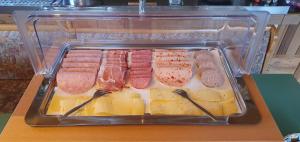 a plastic container filled with different types of meat at Gasthaus Zum Schneider in Pottenstein