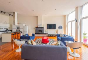 a living room with a blue couch and a table at Spacious House with Large Garden in Jette in Brussels