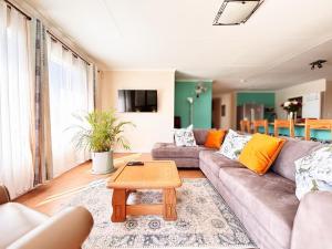 a living room with a couch and a coffee table at Prince and Pooch Self Catering in Windhoek