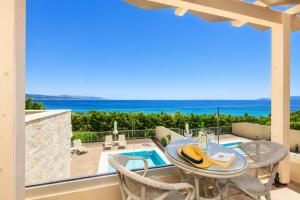 a dining room with a view of the ocean at Villa Alora in Barbati