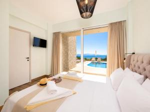 a bedroom with a bed with a view of a pool at Villa Alora in Barbati