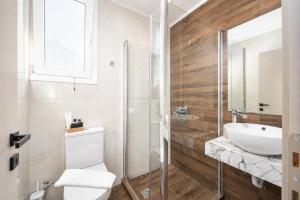 a bathroom with a toilet and a sink at Villa Alora in Barbati +19 photos